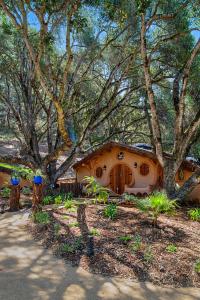 a small house in the middle of some trees at Hobbit Hideout in Watsonville