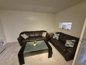 a living room with a couch and a coffee table at Nordic Stay in Grimstad