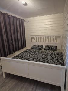 a bedroom with a large bed in a room at Nordic Stay in Grimstad