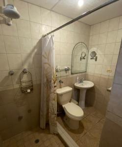 a bathroom with a toilet and a sink at The Mexican in Los Altos de Cerro Azul