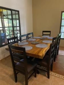 a dining room table with chairs and a large wooden table at The Mexican in Los Altos de Cerro Azul +16 photos