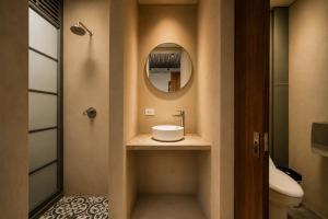 a bathroom with a sink and a mirror at Capybara Hostel - Boutique hostel in Villavicencio