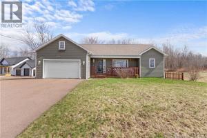 a large house with a garage on a yard at Cue & couch retreat in Dieppe