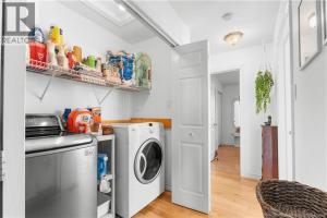 a laundry room with a washer and dryer at Cue & couch retreat in Dieppe