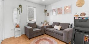 a living room with a couch and a chair at Cue & couch retreat in Dieppe