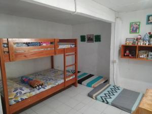 a bedroom with two bunk beds in a room at SJ Transient House in San Fernando