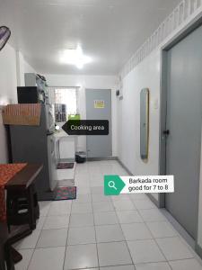 a kitchen with a white tile floor and a door at SJ Transient House in San Fernando