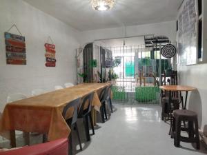 a room with a long table and chairs in it at SJ Transient House in San Fernando