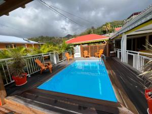 a swimming pool on the deck of a house at Villa LA SUZANNA in Pointe-Noire