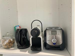 a kitchen counter with a toaster and a toaster at Le Tilleul in Pluvigner