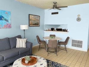 a living room with a couch and a table at Carey Beach Villa in Humacao