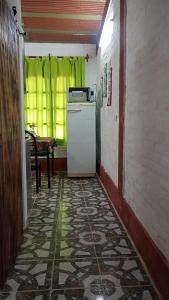a room with a refrigerator and a table with a window at Monoambiente LPS in Santiago del Estero