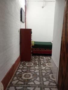 a hallway with a door and a tile floor at Monoambiente LPS in Santiago del Estero +3 photos