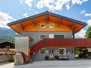 a house with a red roof at Alpenlodge Steiger in Neukirchen am Großvenediger