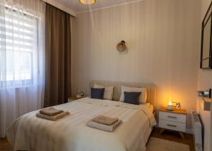 a bedroom with a large bed with two towels on it at Domek dwóch jezior z jakuzzi, Chojno pojezierze Brodnickie in Chojno +55 photos