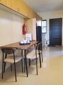 a dining room table and chairs in a kitchen at The Coastal Luxe Suite in Samal