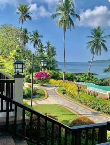 a view from the balcony of a resort with palm trees at The Coastal Luxe Suite in Samal