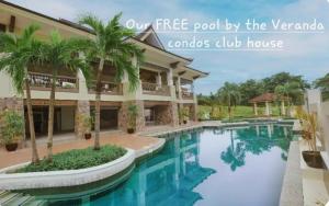 a house with a pool by the yard with palm trees at The Coastal Luxe Suite in Samal