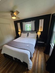 a bedroom with a large white bed with two lamps at Gatliff Getaway in Warsaw