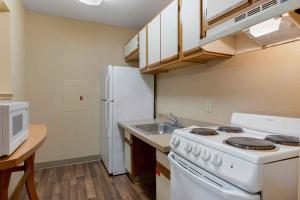 a kitchen with a white stove and a sink at Extended Stay America Suites - Evansville - East in Evansville