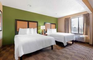 a hotel room with two beds and a window at Extended Stay America Suites - Evansville - East in Evansville