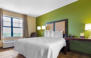 a hotel room with a large bed and a window at Extended Stay America Suites - Chicago - Gurnee in Gurnee +32 photos