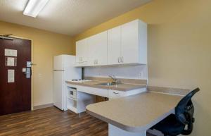 a kitchen with white cabinets and a sink and a counter at Extended Stay America Suites - Chicago - Gurnee in Gurnee