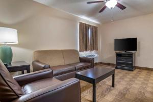 a living room with a couch and a flat screen tv at Extended Stay America Suites - Greensboro - Airport in Friendship