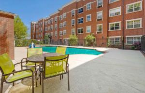 a patio with a table and chairs in front of a building at Extended Stay America Suites - Greensboro - Airport in Friendship