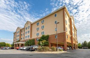 a large building with cars parked in a parking lot at Extended Stay America Suites - Washington, DC - Springfield in Springfield