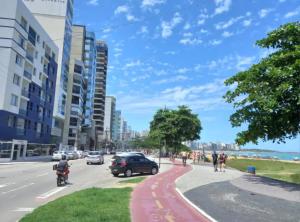 a street in a city with cars on the road at Flat Praia da Costa in Vila Velha
