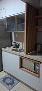 a kitchen with a sink and a counter top at Flat Praia da Costa in Vila Velha +1 photo