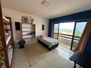 a bedroom with a bed and a view of the ocean at Salvador Backpackers House in Salvador