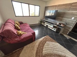a bedroom with a bed and a flat screen tv at Salvador Backpackers House in Salvador
