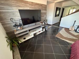 a living room with a large flat screen tv on a wall at Salvador Backpackers House in Salvador