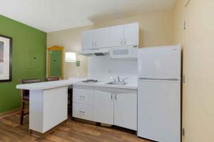 a kitchen with white cabinets and a white refrigerator at Extended Stay America Suites - Washington, DC - Fairfax - Fair Oaks in Fairfax