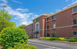 a red brick building with a street in front at Extended Stay America Suites - Boston - Woburn in Woburn