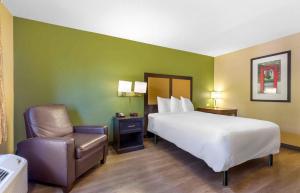 a hotel room with a bed and a chair at Extended Stay America Suites - Chesapeake - Greenbrier Circle in Chesapeake +45 photos