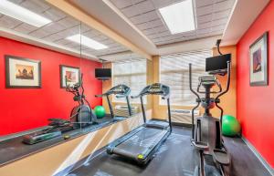 a gym with two exercise bikes and red walls at Extended Stay America Suites - Chesapeake - Greenbrier Circle in Chesapeake
