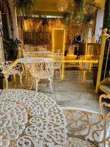 a room with white tables and chairs in a building at Hotel Museo Carnaval in Huejotzingo