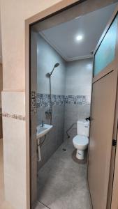 a bathroom with a toilet and a sink at VibeLine Surf Camp in Tamraght Ouzdar