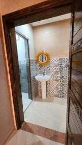 a bathroom with a sink and a mirror at VibeLine Surf Camp in Tamraght Ouzdar
