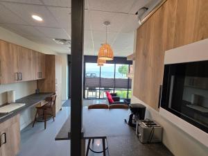 an office with a kitchen and a living room at Lakeview Main Floor Suite 104 in Peachland