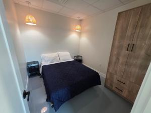 a bedroom with a bed and a wooden door at Lakeview Main Floor Suite 104 in Peachland