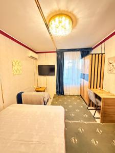 a room with a table and chairs and a television at Heyvah - Guest House in Tashkent in Tashkent