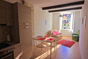 a kitchen and living room with a table and a couch at Vernazza Vacation 2 in Vernazza