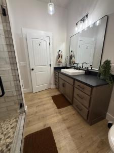 a bathroom with a sink and a large mirror at Home Town Mountain Lodging 2 in Darby +26 photos