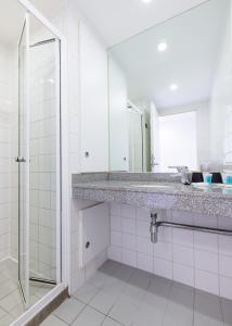 a bathroom with a sink and a mirror at Princes Gardens in London