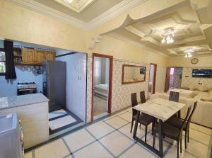 a kitchen and dining room with a table and chairs at Villa Drayd in Ait Melloul