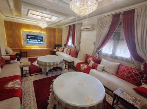 a living room with a couch and a table at Villa Drayd in Ait Melloul